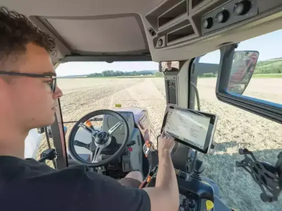 Fører bruker kontrollskjerm i førerhuset på en traktor fra Case IH Maxxum-serien.