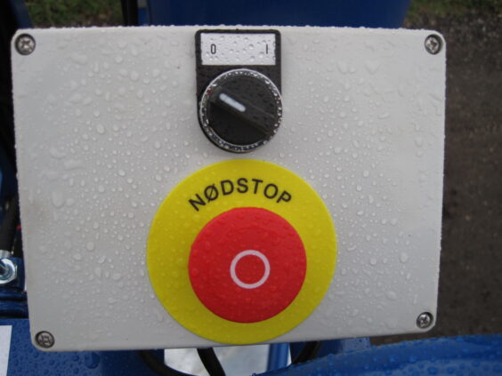 Kontrollpanel med nødstopp for ØRUM GMD-8600 gjødselmikser dekket i vanndråper.