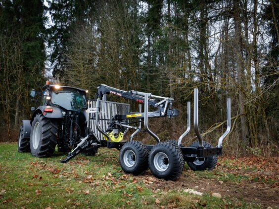 Traktor med en PALMS 3.67 skogskran montert på tømmervogn i en høstskog.