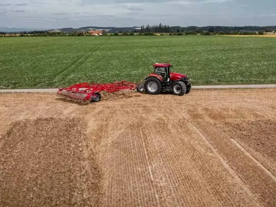 Case IH Optum med harv langs kanten av åkeren