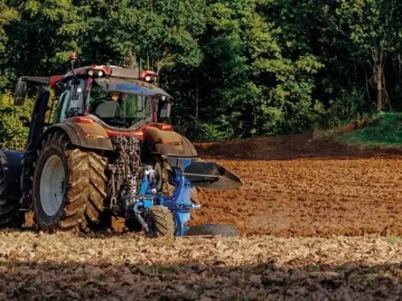 Traktor med Överum Vari-Flex CX vendeplog i arbeid
