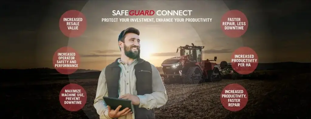 En smilende bonde med nettbrett foran en Steiger 785 Quadtrac traktor i solnedgang.