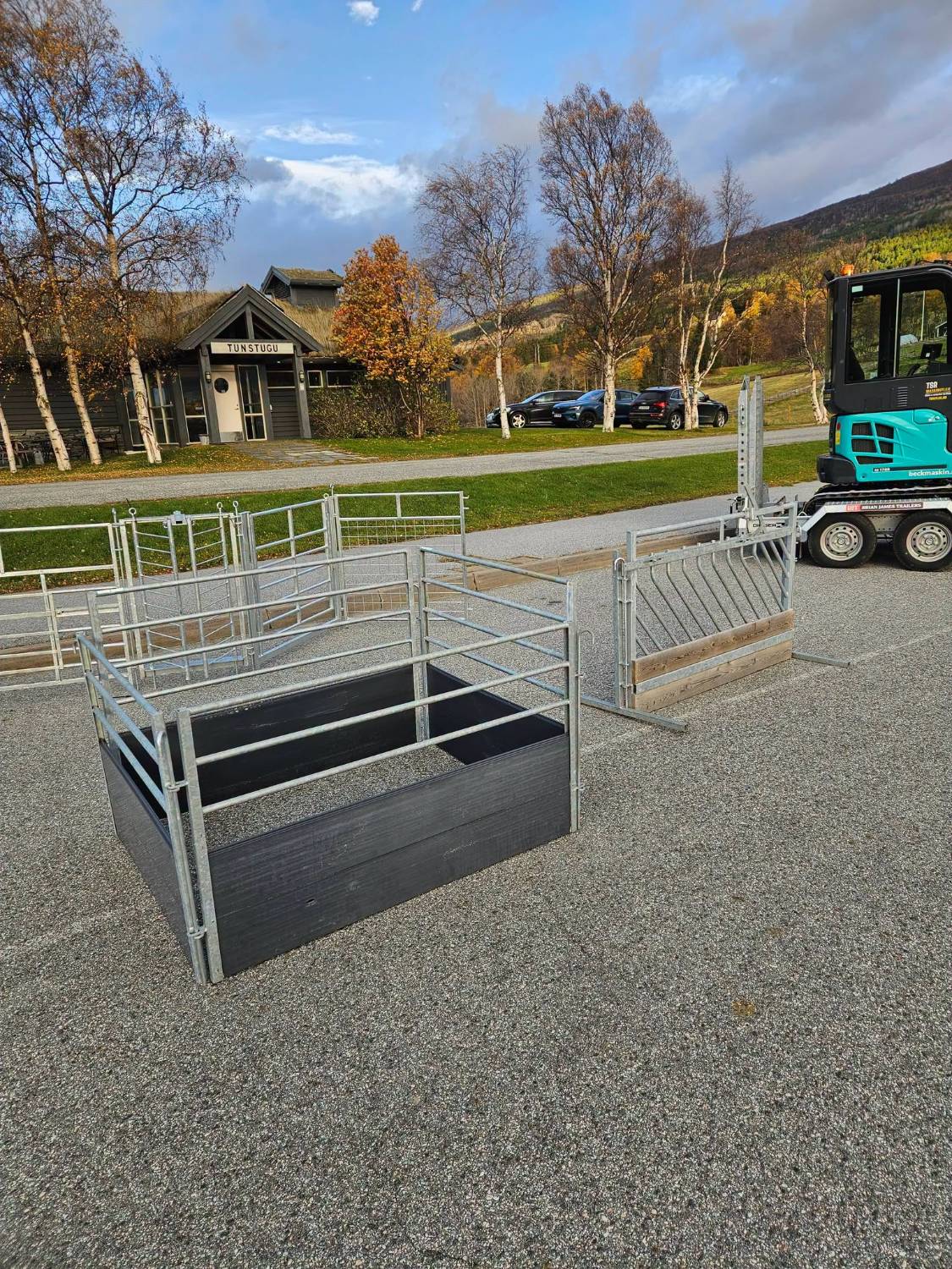 Lammebinge med svarte plater og galvaniserte rør, og en etefront med skrå stenger for sau, utstilt under Veddrock på Lesja.